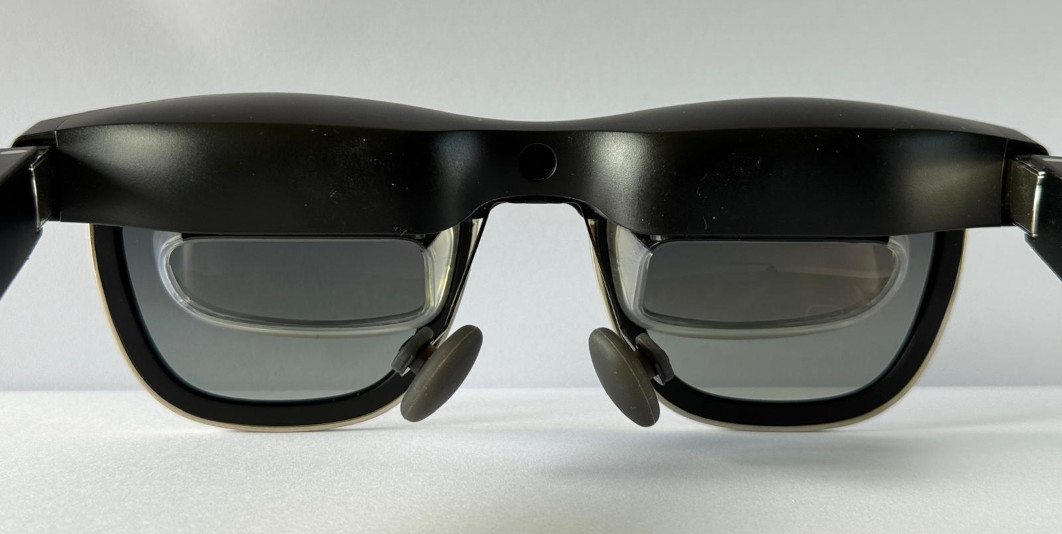 A paitr of smart glasses seen from the back. The tiny AR screens positioned behind the glass lenses are more clearly visible.